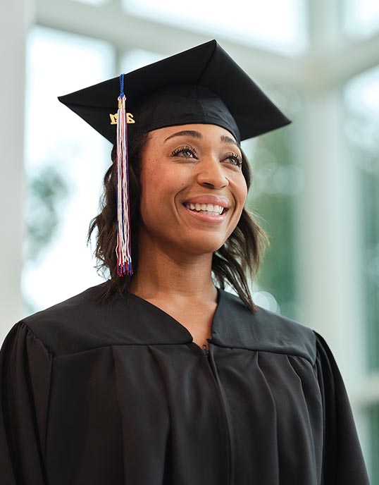 Joyce University graduate in cap and gown