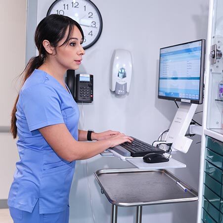 Joyce University student learning skills in dispensary simulation lab