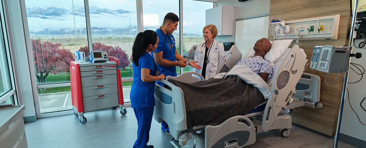 Joyce University faculty instructing nursing students in simulation lab on high-fidelity mannequins