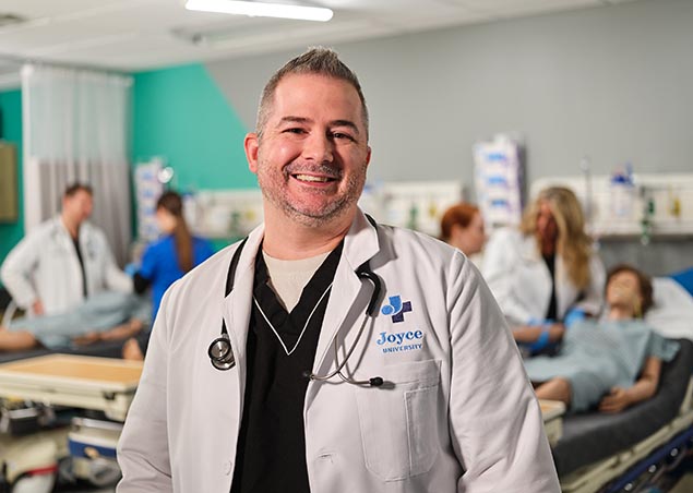 Joyce instructor in white coat in the Joyce skills lab