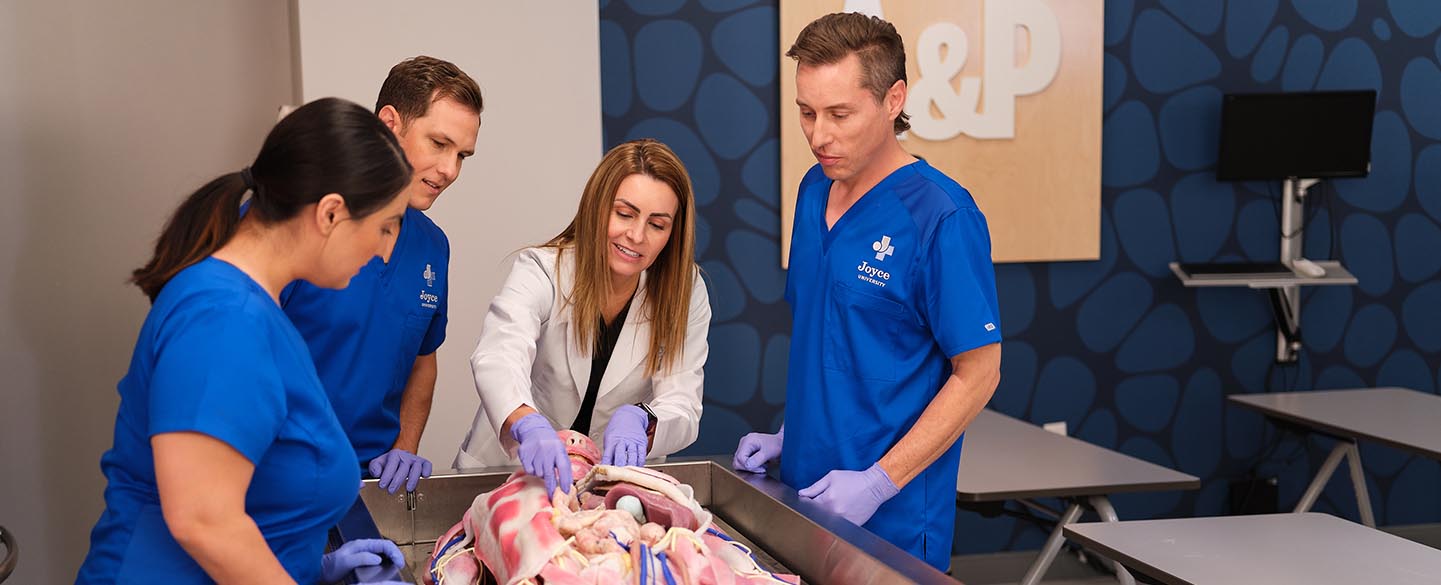 Joyce University faculty demonstrating skills on synthetic cadaver to nursing students