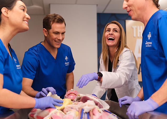 Joyce nursing instructor and students working with synthetic cadaver