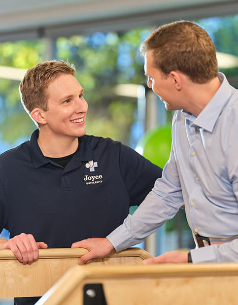 Joyce University OTA student learning from instructor in campus skills lab