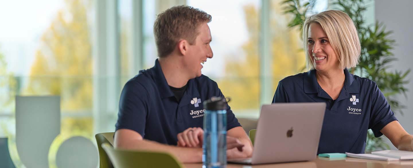 Two joyce university OTA students studying in student study center