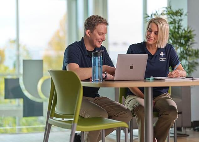 Two occupational therapy assistant students studying in the student study center