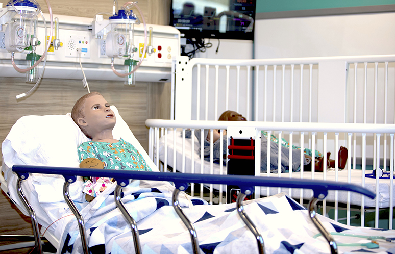 Pediatric high fidelity mannequin in hospital bed in Joyce Johnson center of simulation