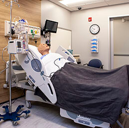 High-fidelity mannequin in hospital bed in the Joyce Johnson center of simulation
