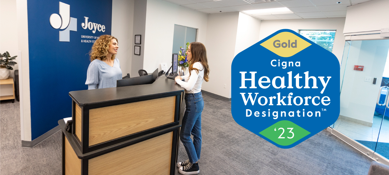 Two staff members at Joyce University standing at the reception desk
