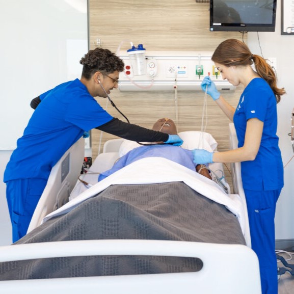 Nursing students practicing on high fidelity patient simulator