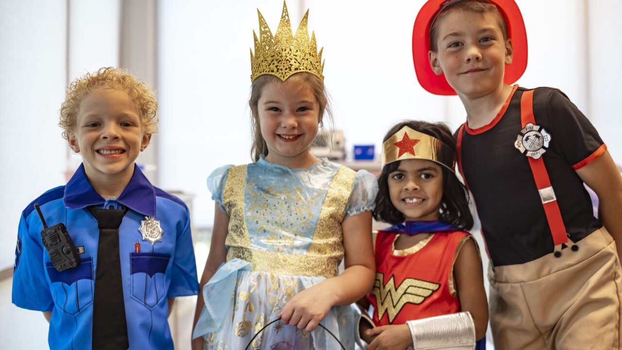 Four kids in halloween costumes