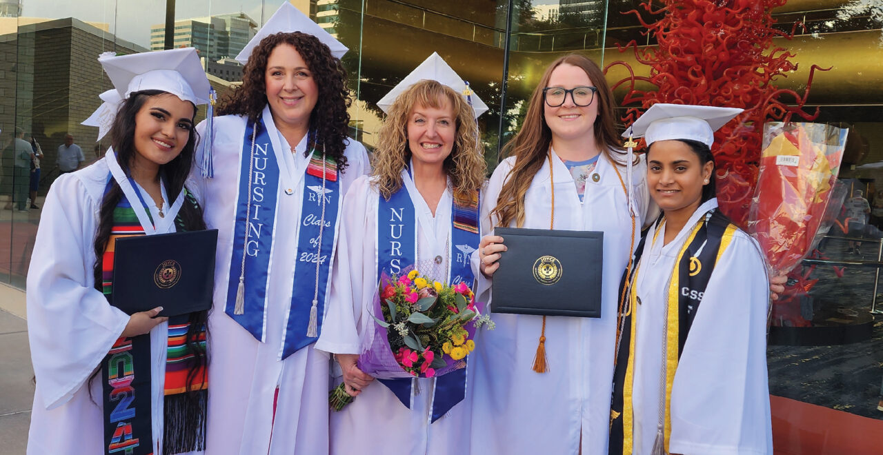 Five Nursing Students in White Cap and Gowns Post for Picture