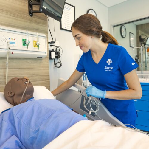 Joyce University nursing student practicing on patient mannequin in Joyce Johnson Center of Simulation in Draper Utah