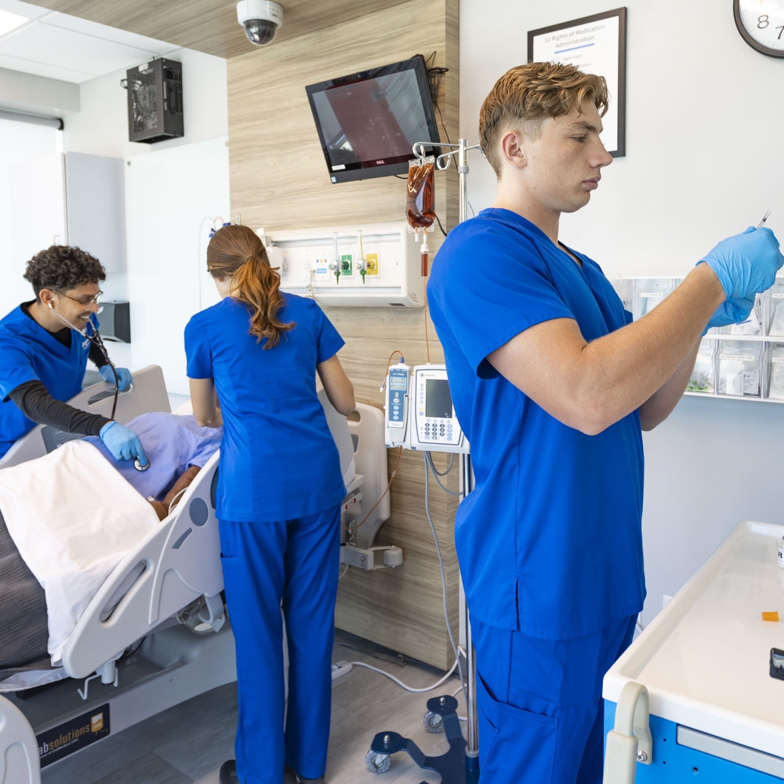 joyce nursing students practicing on high-fidelity patient simulator in simulation center