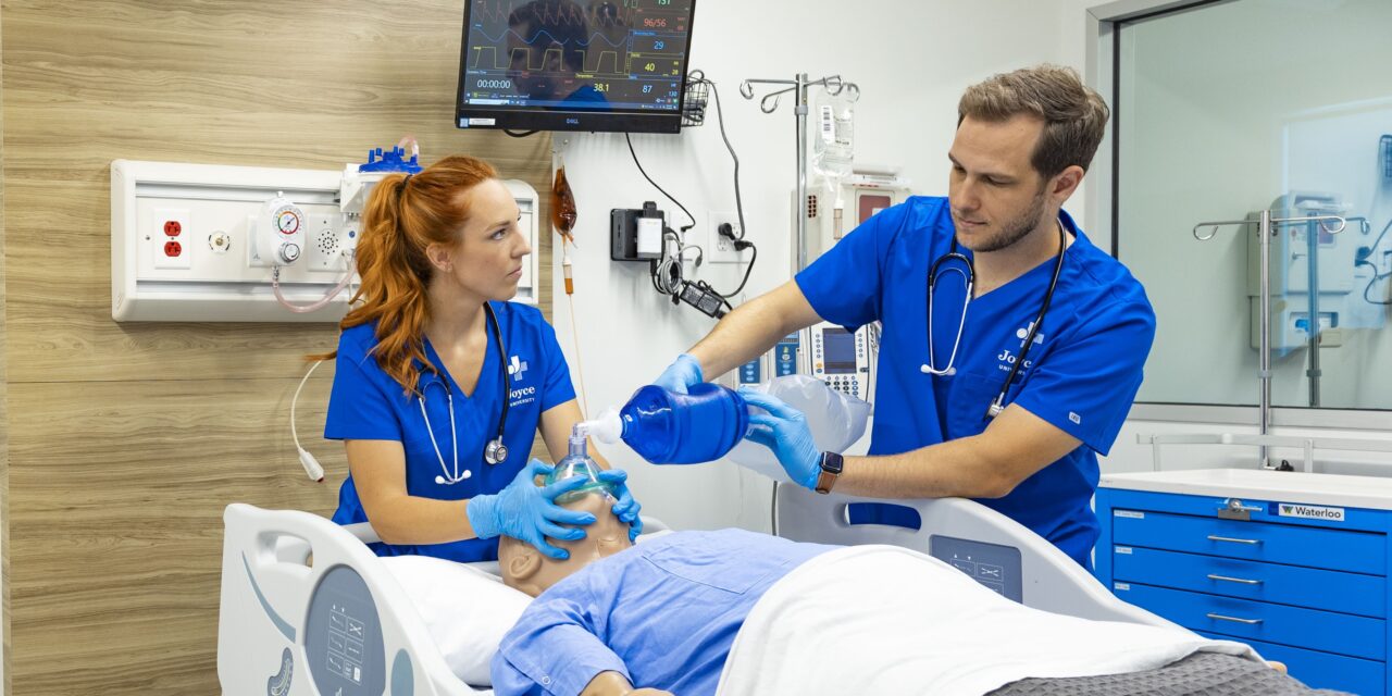 nursing students practicing on a high-fidelity patient simulator at the joyce university center of similation