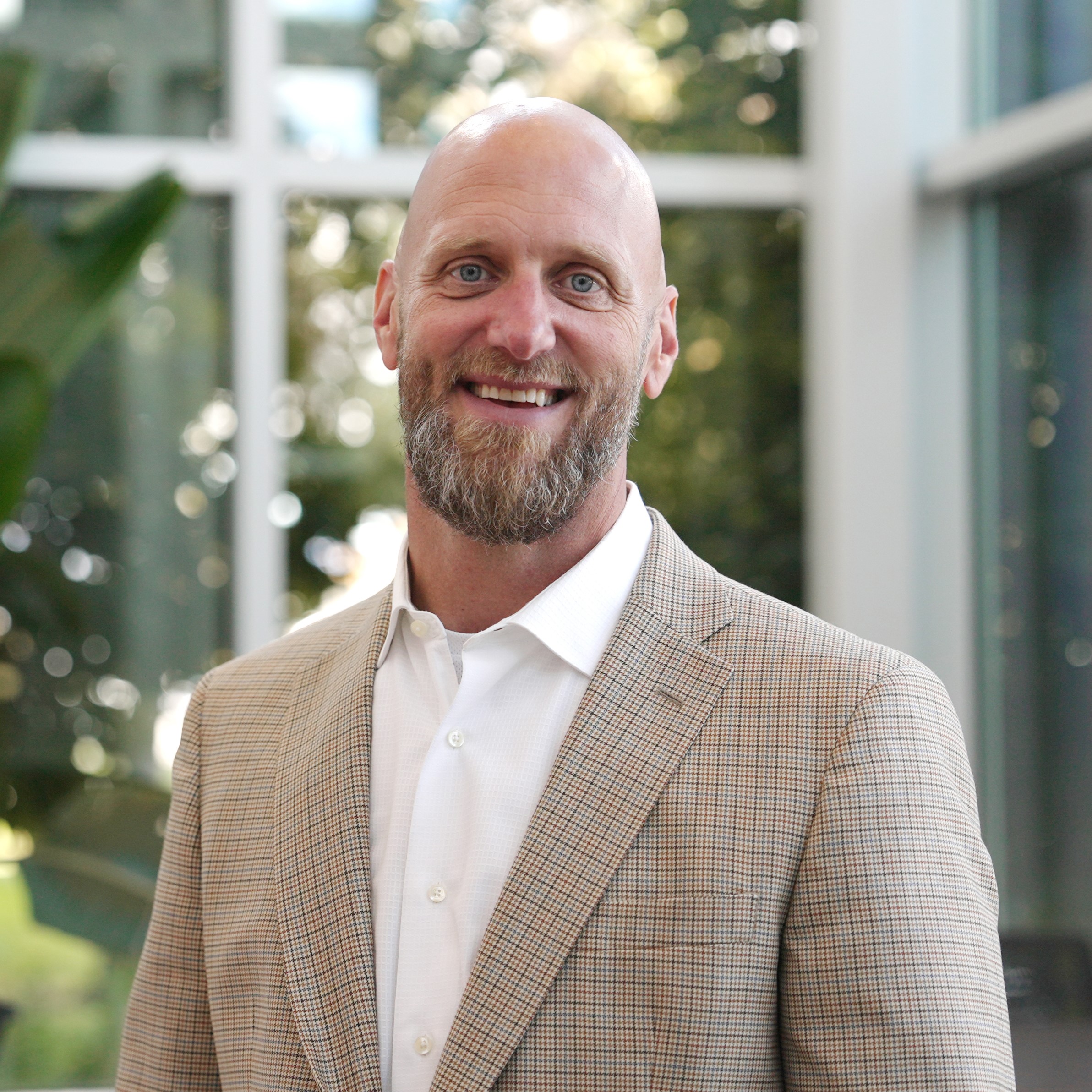 Phillip Kagol Vice President of Enrollment Management standing in front of campus atrium