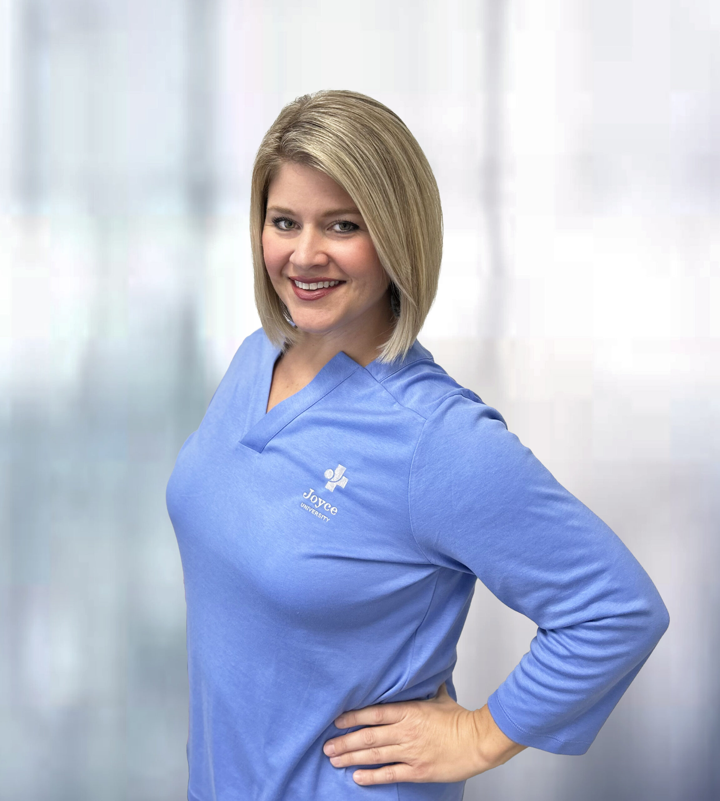 Jenifer Ayotte Dean of General Education & Health Sciences standing in front of a blurred background